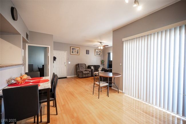 Dining space with visible vents, ceiling fan, light wood finished floors, and baseboards | Image 10