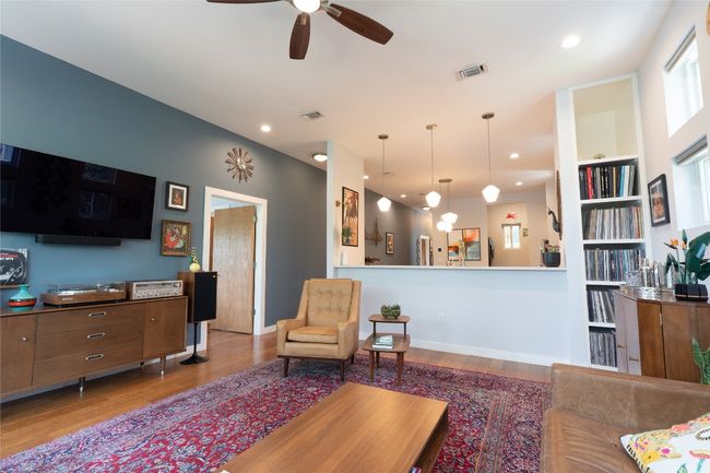 Living area with wood finished floors, ceiling fan, and recessed lighting | Image 32