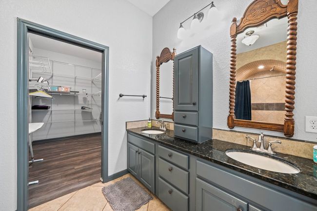 Full bath with double vanity, tile patterned flooring, a sink, and a walk in closet | Image 18