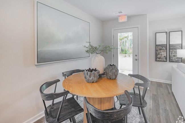 Dining area with wood finished floors | Image 9