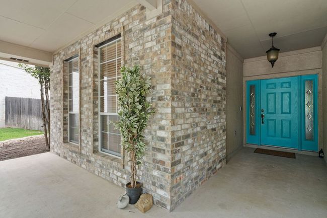 Property entrance with brick siding and a porch | Image 5