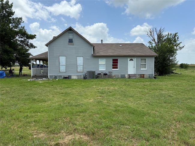 Rear view of house featuring central AC unit, a shingled roof, and a yard | Image 7