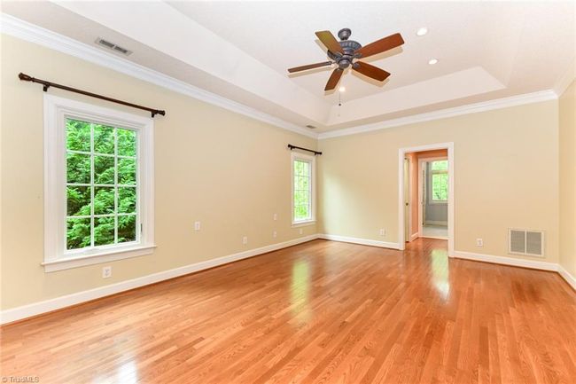 Primary bedroom offers hardwood floors and lots of natural light | Image 12