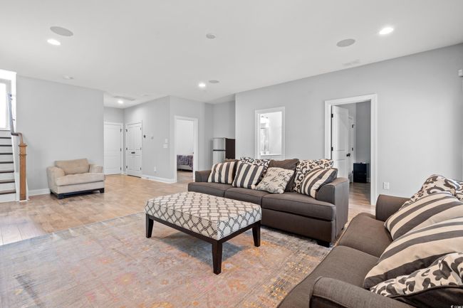 Living room featuring light wood-type flooring, stairway, and recessed lighting | Image 19