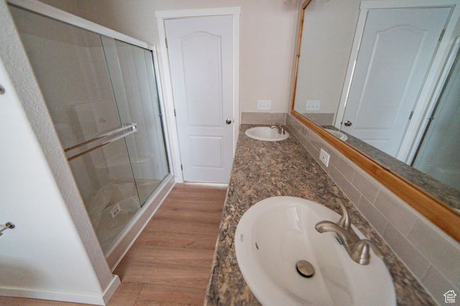 Full bathroom featuring a sink, double vanity, and a stall shower | Image 31
