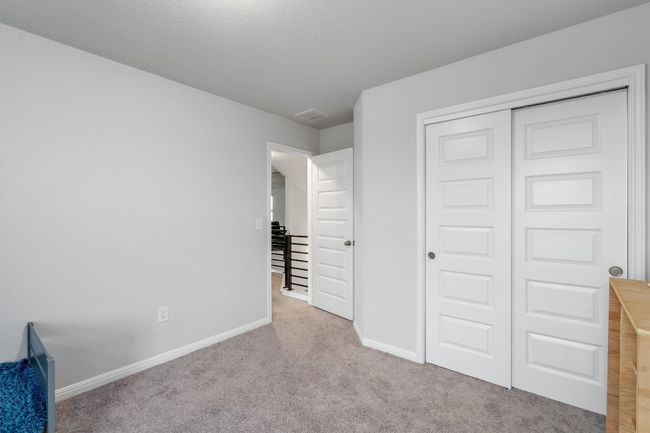 Unfurnished bedroom with baseboards, carpet flooring, and a closet | Image 26