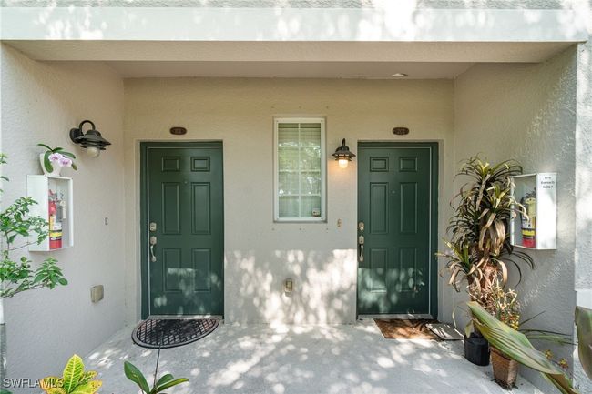 View of exterior entry featuring stucco siding and a porch | Image 18