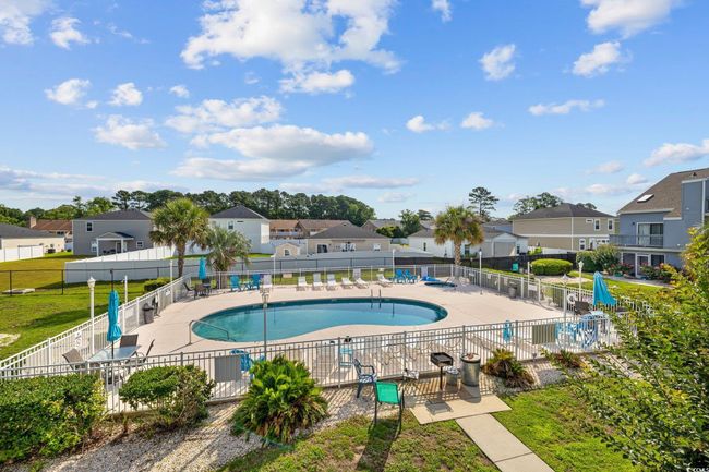 Community pool with a residential view and a patio area | Image 21