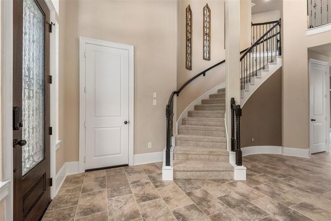 Another view of the grand entrance with sweeping staircase. The circular nook is the perfect spot for the Christmas tree. | Image 7