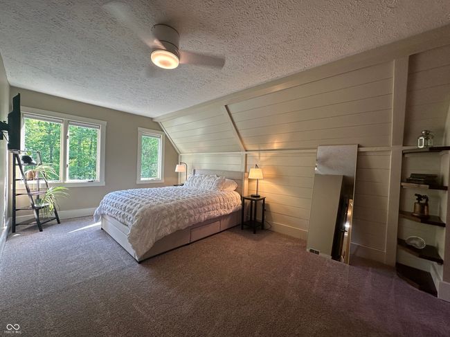 bedroom featuring vaulted ceiling, a textured ceiling, carpet floors, ceiling fan, and baseboards | Image 27