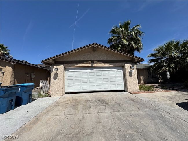 View of front of home featuring concrete driveway, an attached garage, and stucco siding | Image 16