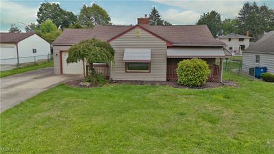 View of front of property featuring a garage and a front yard | Image 1