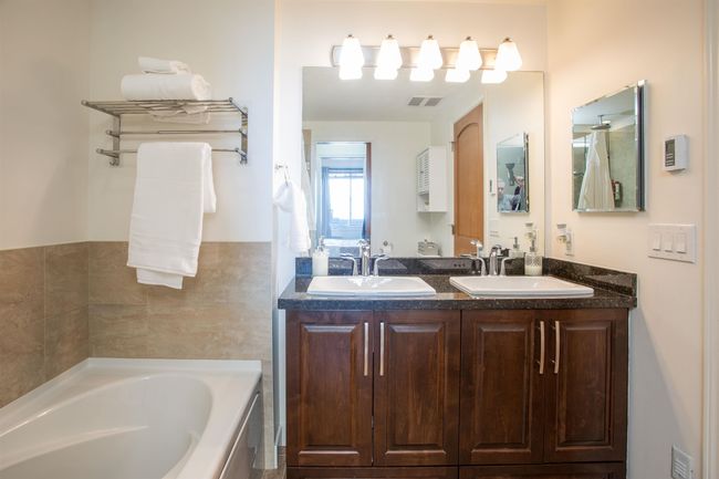 Bathroom featuring a garden tub, double vanity, a sink, and visible vents | Image 20