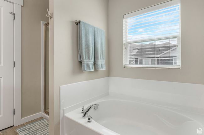 Bathroom featuring a stall shower and a bath | Image 16