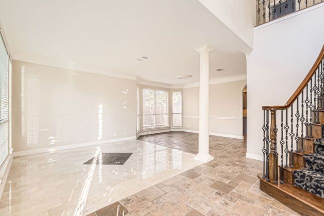 Foyer entrance with arched walkways, ornate columns, visible vents, stairway, and baseboards | Image 19
