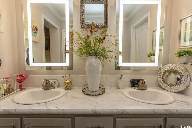 Bathroom featuring double vanity, crown molding, and a sink | Image 31