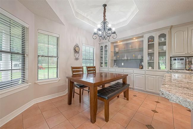 Dining room with rear window views and built-in cabinetry | Image 9