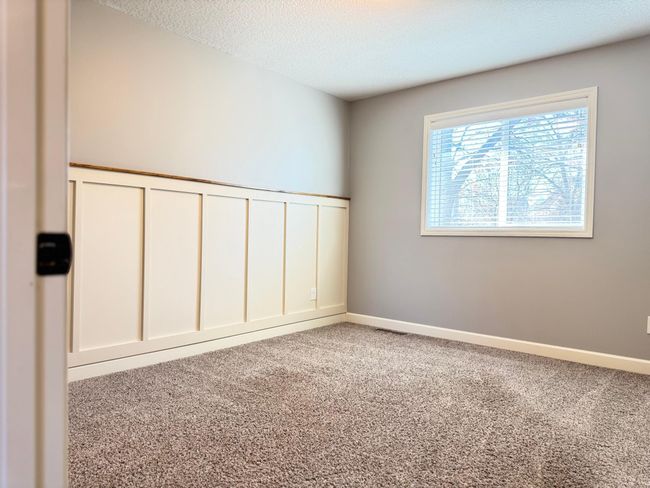 Upper Bedroom #3 Features Adorable Beadboarding and Overlooks Wooded Backyard. | Image 12