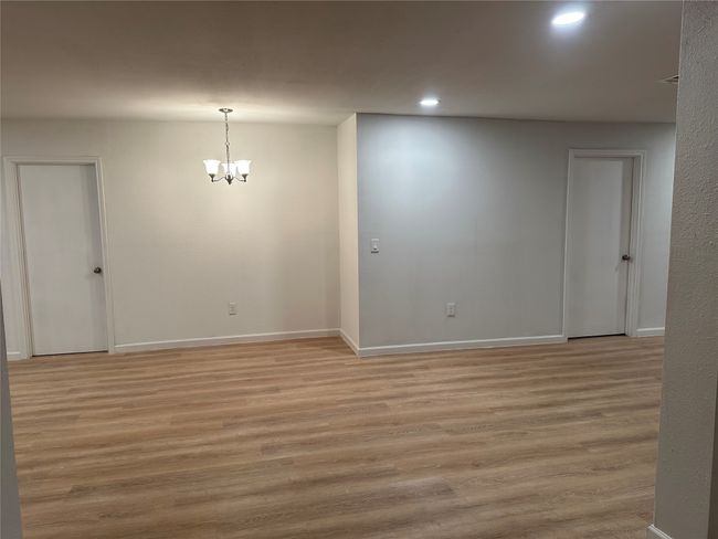 Empty room featuring recessed lighting, light wood-style floors, baseboards, and an inviting chandelier | Image 25