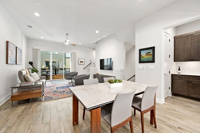 Open floorplan connects cooking, dining interior living and outside living. Notice the dry bar to the right side of photo. | Image 9