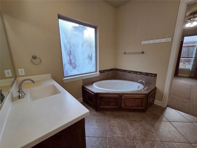 Full bath featuring vanity, a garden tub, and tile patterned flooring | Image 21