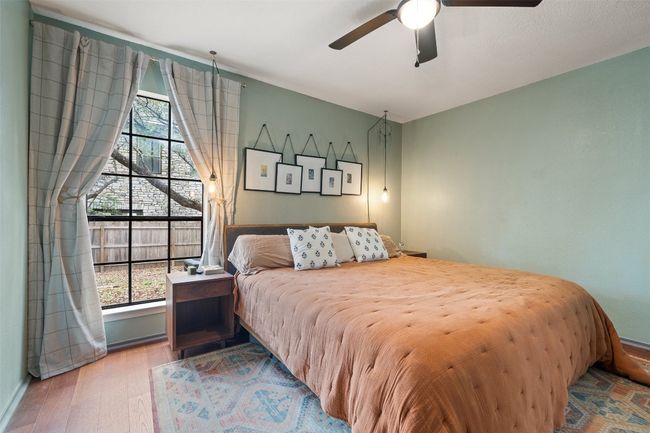 Bedroom featuring baseboards, a ceiling fan, and wood finished floors | Image 4