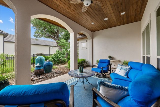 Day view of patio terrace and water feature. | Image 28