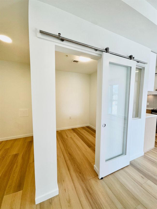 Empty room with baseboards, visible vents, and light wood-type flooring | Image 16
