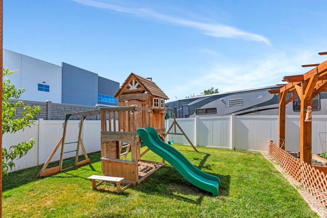 View of playground with a fenced backyard | Image 25