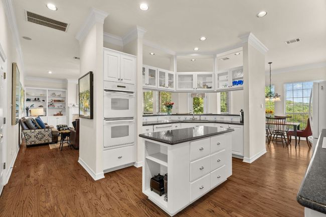 Kitchen with a double oven is open to the den. | Image 14