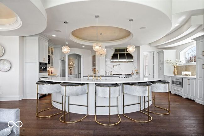 You'll be impressed by this uniquely designed rounded, oversized island with seating. | Image 16