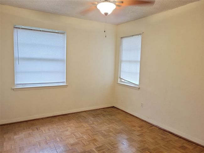 Empty room featuring ceiling fan, baseboards, and a textured ceiling | Image 11