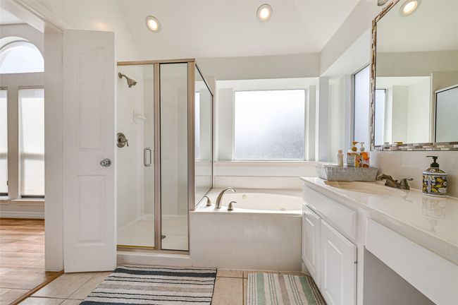 Bathroom with vanity, plenty of natural light, and plus walk in shower | Image 32