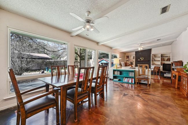 Spacious open living and dining space with a wall of windows to brighten the space. | Image 5