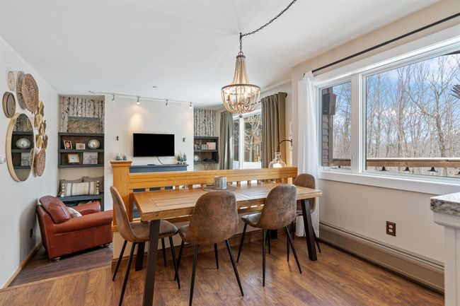 Looking from the kitchen, at the dining area and living area. | Image 4