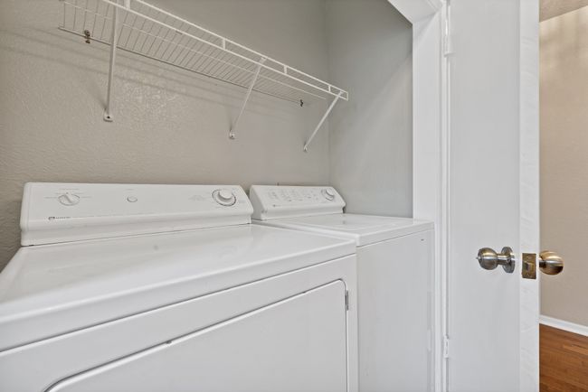 Laundry closet in hall bathroom featuring full size washing machine and clothes dryer laundry area | Image 22