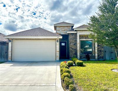 View of front of house with a front yard and a garage | Image 1