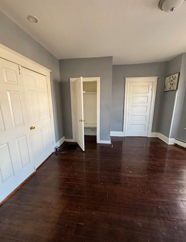 Unfurnished bedroom featuring hardwood / wood-style floors and baseboards | Image 6