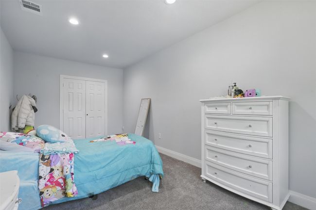 Bedroom featuring carpet floors, baseboards, recessed lighting, and a closet | Image 29