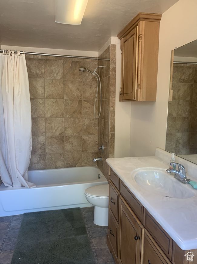Bathroom featuring shower / bath combo with shower curtain, vanity, and toilet | Image 26