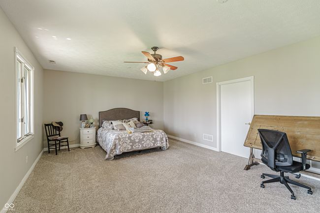 4th bedroom in basement with baseboards, a ceiling fan, carpet flooring, and visible vents | Image 33