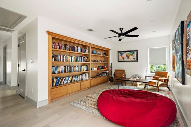Sitting room featuring wood finished floors, visible vents, baseboards, and ceiling fan | Image 23