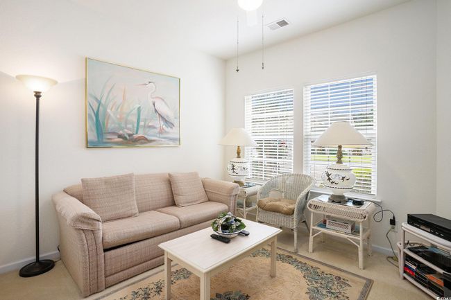 Living area with plenty of natural light, carpet floors, and ceiling fan | Image 14