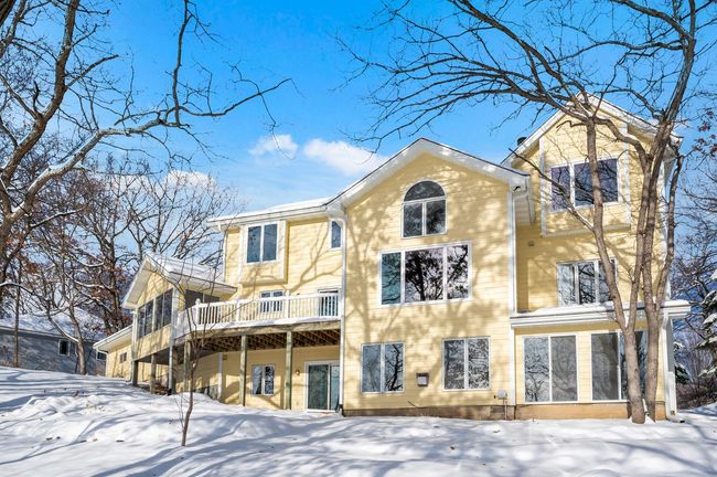 There are an impressive number of windows in the home that face the lake. This allows a substantial amount of natural light into the home year-round. | Image 35