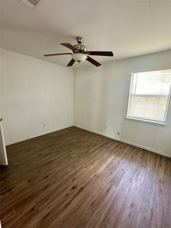 Empty room featuring dark wood-style floors and a ceiling fan | Image 13
