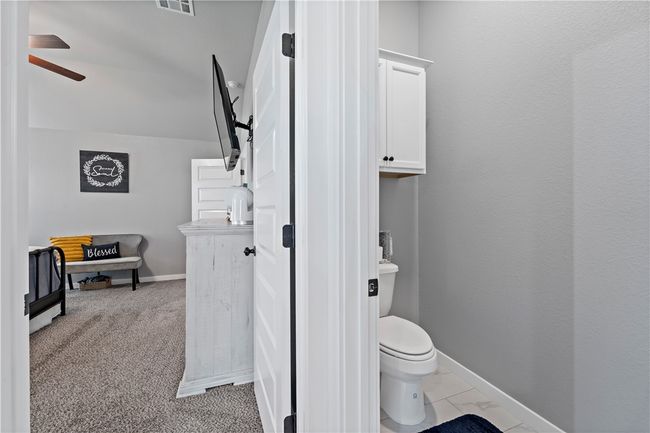 Bathroom featuring baseboards, visible vents, ceiling fan, and toilet | Image 23