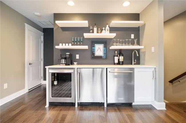 Third floor Wet Bar has a wine fridge, stainless steel mini fridge, stainless steel dishwasher and bar sink! Great for entertaining on the extra large 3rd floor covered deck! | Image 35