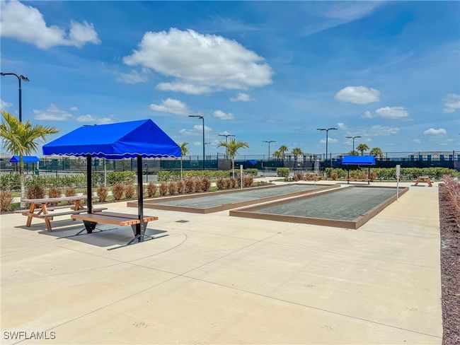 View of community featuring a bocce ball area and fence | Image 46