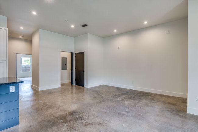 Spare room featuring finished concrete floors, electric panel, and recessed lighting | Image 4