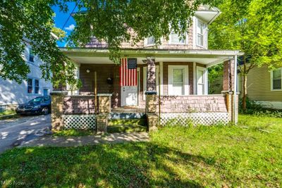 View of front of house with covered porch and a front yard | Image 1